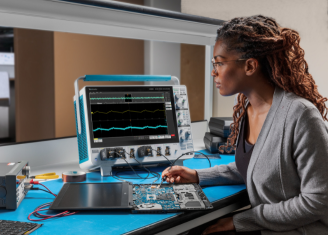 Female developer using oscilloscope